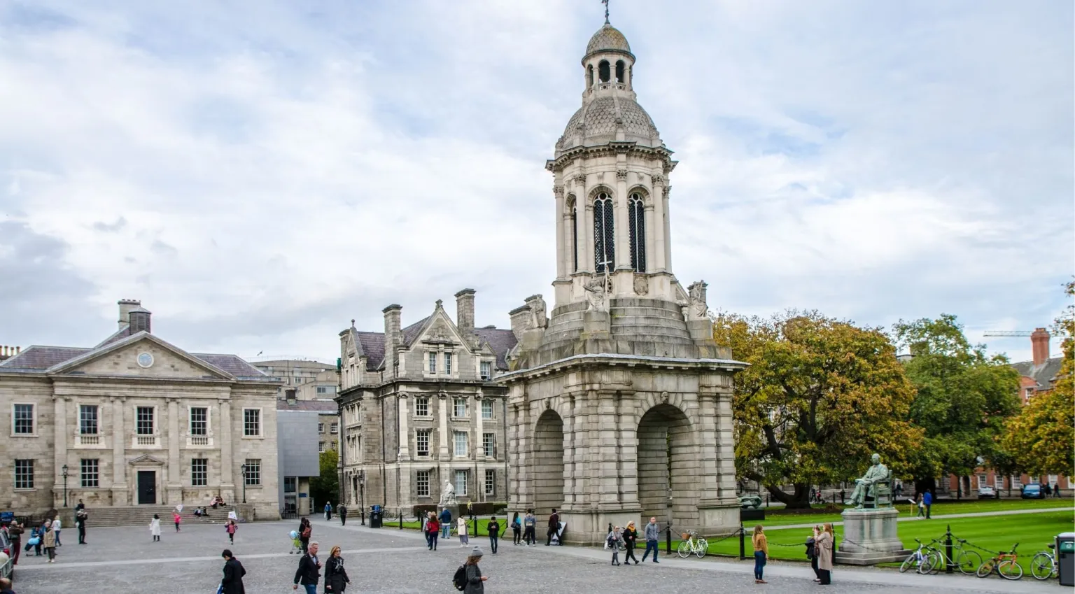 Trinity College Dublin front square with the Campanile, George Salmon statue and visitors